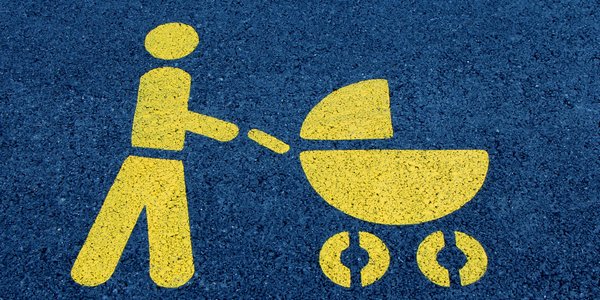 Eine Mutter mit Kinderwagen als Symbol auf einer Straße